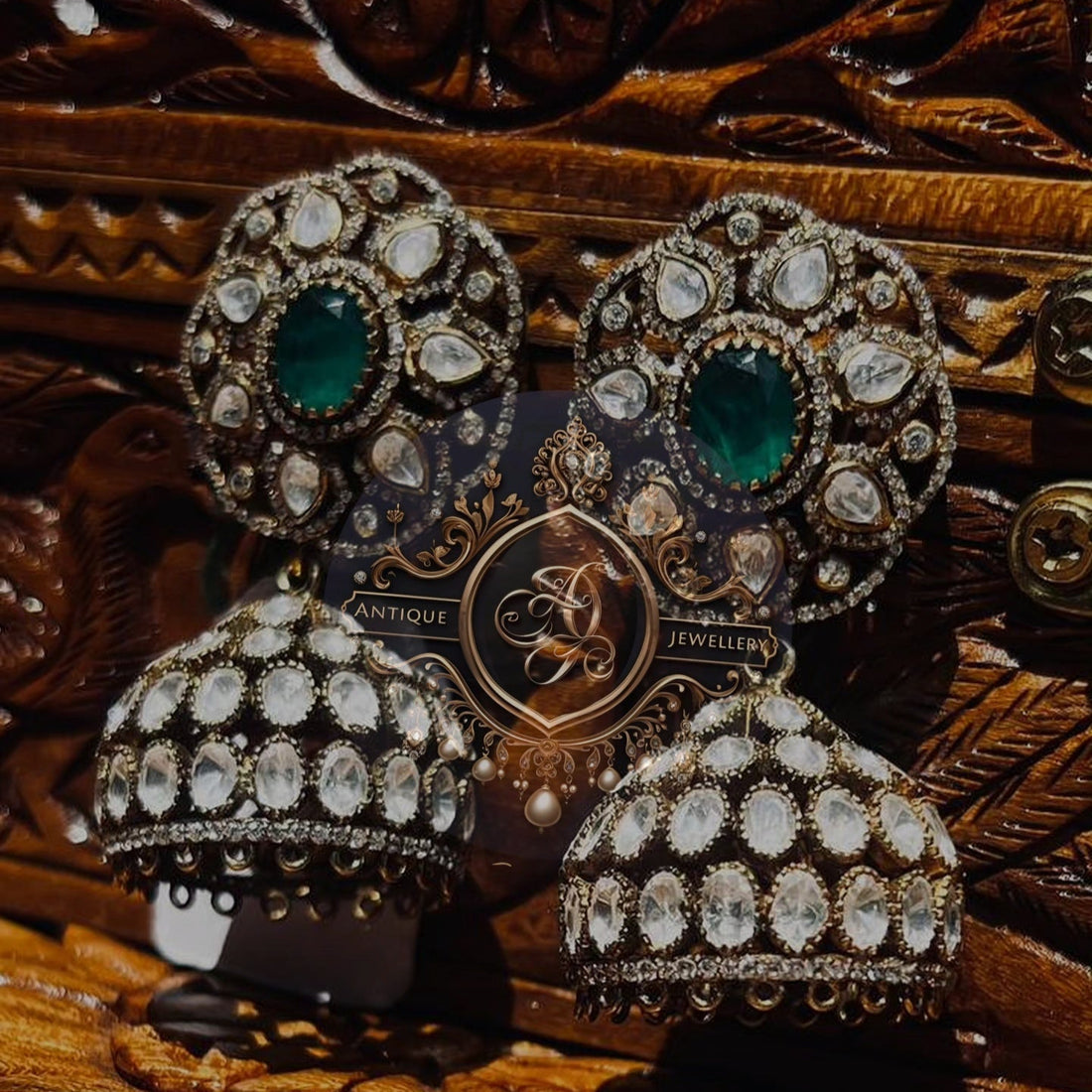 Noor Emerald Jhumkas earrings featuring intricate designs and vibrant emeralds, perfect for ethnic wear.