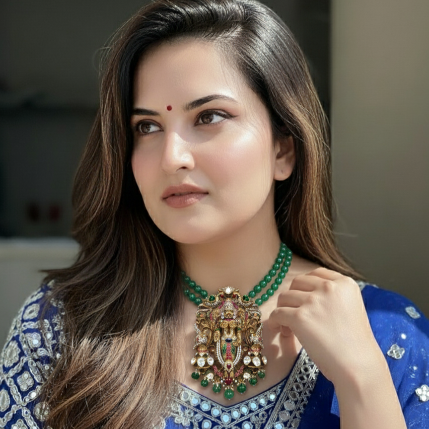 Elegant woman wearing a Divine Lord Venkateswara pendant with green beads and traditional attire.